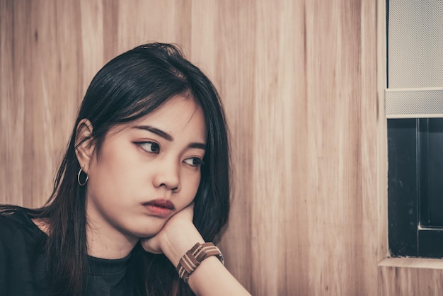 Close up sad beautiful asian woman from unrequire loveshe think so much about boyfriendlife without lovesad woman heartbreak conceptsad woman concept on dark tone