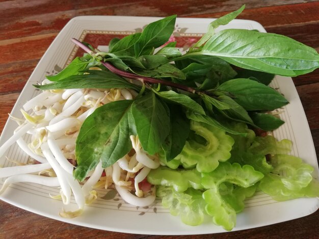 Photo close-up of salad served in plate on table