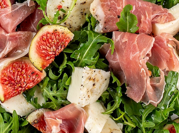 Close up Salad with arugula figs prosciutto and mozzarella