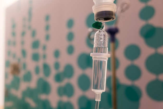 Photo close up saline solution drip for patient and infusion pump in hospital