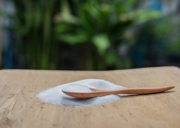 Photo close-up of salt and wooden spoon on cutting board