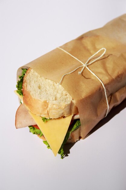 close up of sandwich with ham and cheese, white background