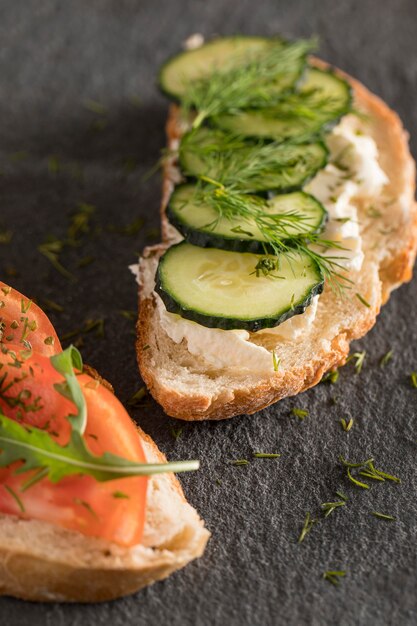 Close-up of sandwiches with tomatoes, cucumber and dill