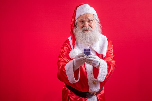 Close-up of Santa's gloved hand holding a ring.