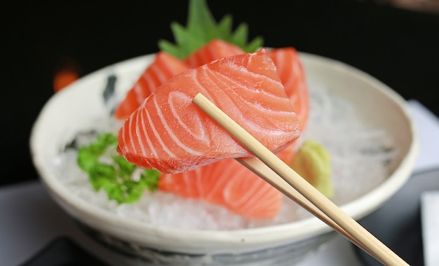 Close-up sashimi salmon on chopstick