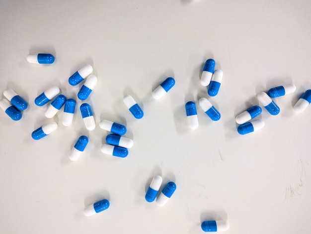 Close-up of scattered capsules over white background