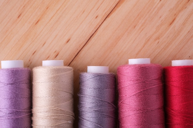 Close up of scattered colorful cotton thread coils