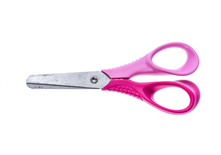 Photo close-up of scissor over white background