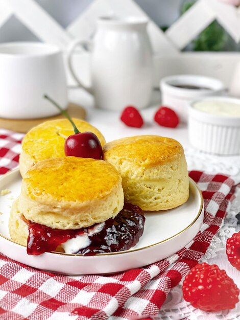 Close up of  scone with the strawberry served on white table for tea time