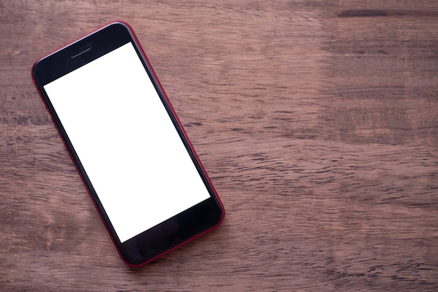 Photo close-up screen mock up mobile phone on a wooden floor