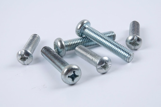 Photo close-up of screws on white background