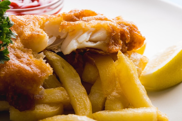 Close-up of seafood with french fries in plate, copy space