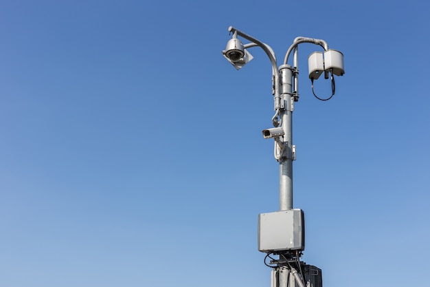 Close up Security CCTV camera operating on the road and blue sky background