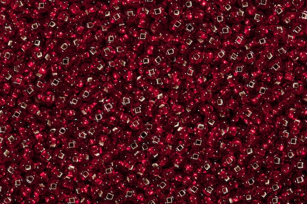 Close up of seed beads of dark red color