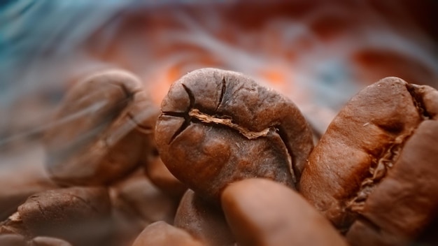 Close up of seeds of coffee Fragrant coffee beans are roasted smoke comes from coffee beans