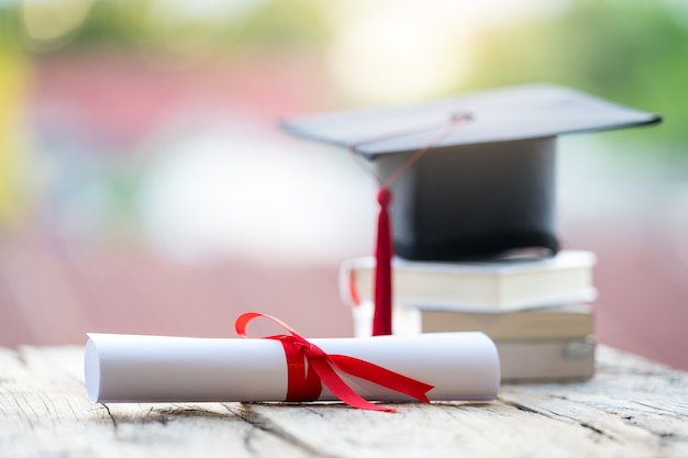 Close-up selective focus of a graduation cap or mortarboard and
diploma degree certificate put on table