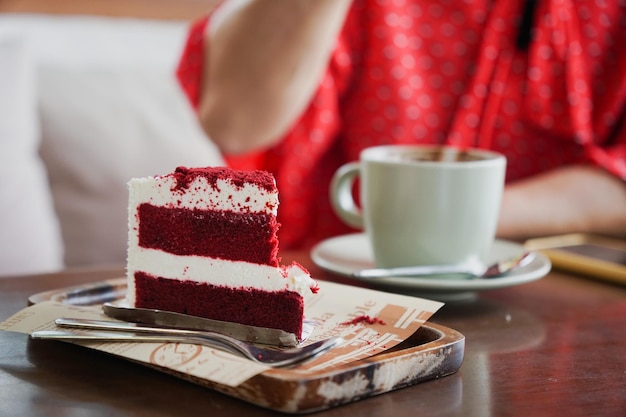 Close up and selective focus red beverages cake white blurred person eating background.