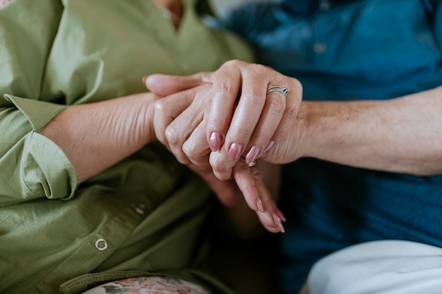 Close-up of senior couple holding hands