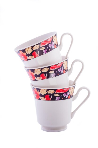 Close-up set of beautiful cobalt white vintage porcelain tea cups with floral pattern on white background. Copy space.