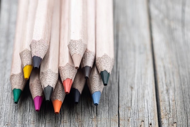 Close-up set of colored pencils for drawing on blurred background copy space.