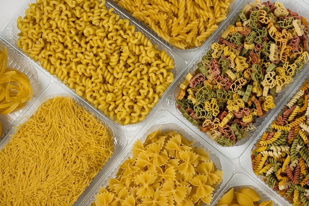 Close up of several types of pasta on white background