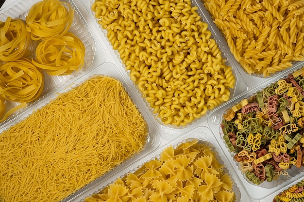 Close up of several types of pasta on white background