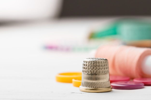 Close up of sewing accessories on table