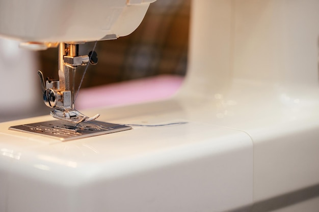 Photo close-up of the sewing machine and sewing needle studio macro