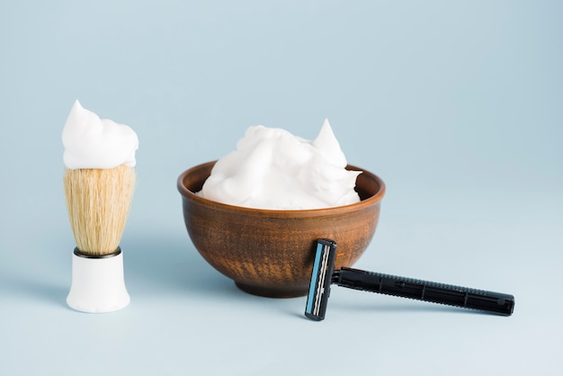 Close-up of shaving accessories for man on blue background