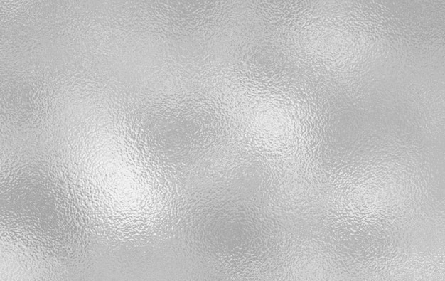 a close up of a shiny metal surface with a shiny silver background