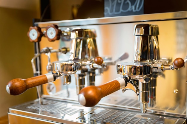 Close-up of shiny wood and still lever espresso machine. Selective focus.