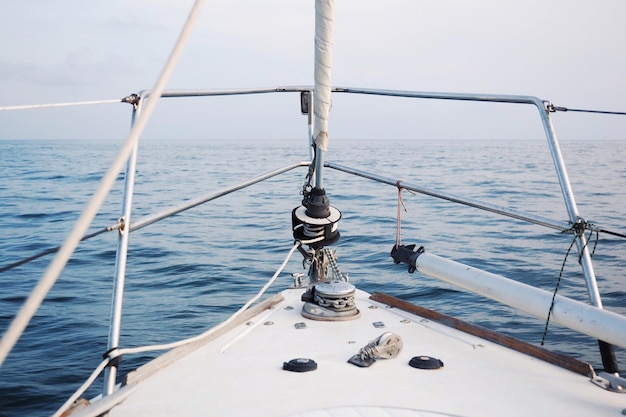 Close-up of ship sailing in sea against sky