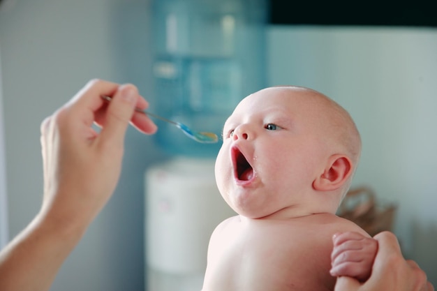close-up of shirtless baby eating