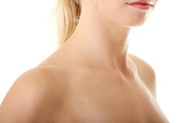 Close-up of shirtless young woman over white background