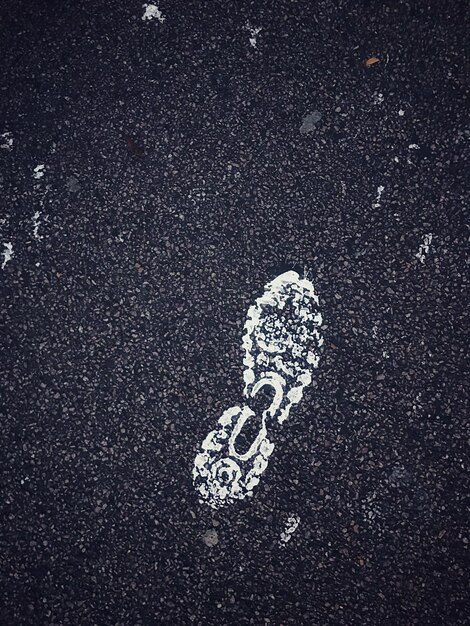 Close-up of shoe print on road