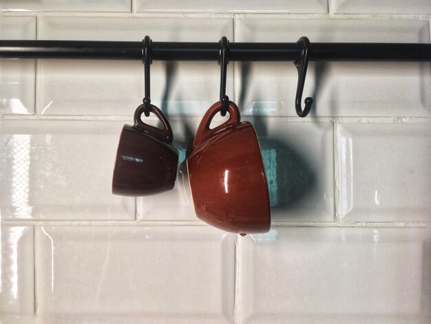 Close-up of shoes hanging on wall at home