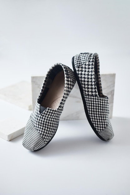 Close-up of shoes on table against white background