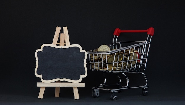 Close-up of shopping cart against black background