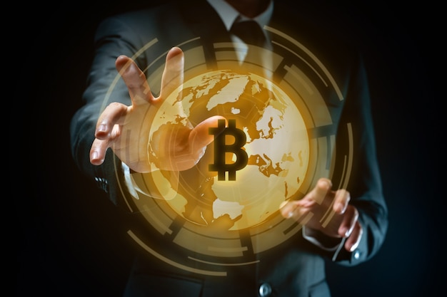 Close up shot of Businessman in black suit with bitcoin symbol hologram effect.