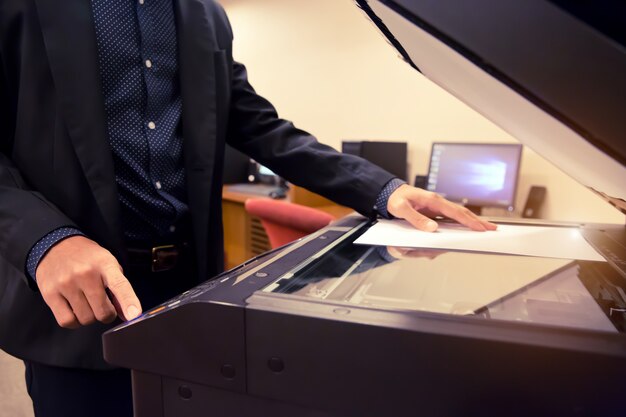 Close-Up Shot Businessman using photocopiers.