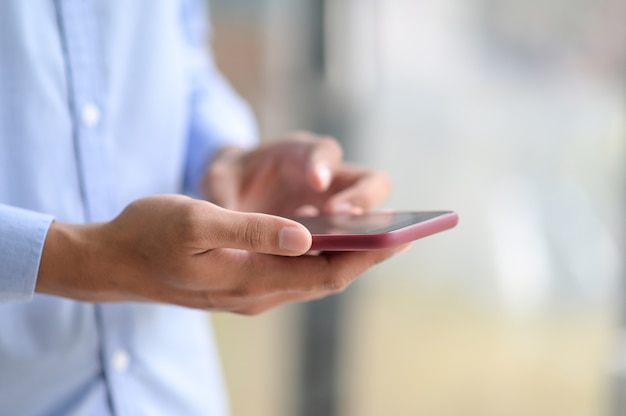 Close up shot of businessman using smartphone