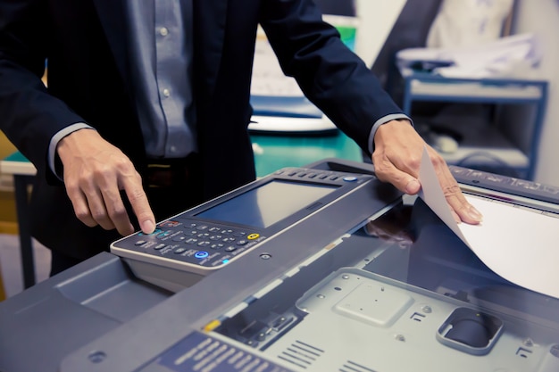 Close-Up Shot Businessmen are using photocopiers.