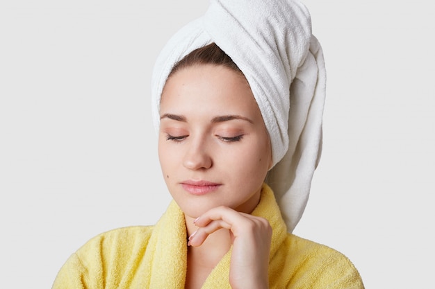 Close up shot of calm relaxed young woman has fresh skin