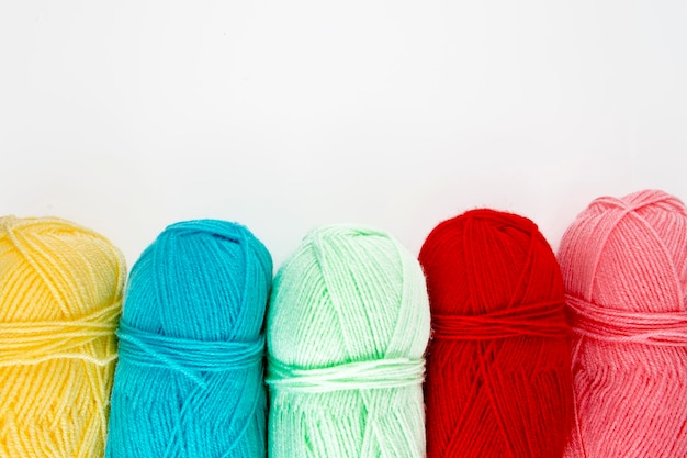 Close up shot of colored wool yarn balls as background
