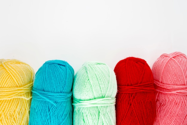 Photo close up shot of colored wool yarn balls as background