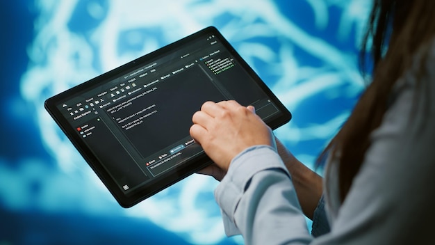 close up shot of computer scientist using tablet in ai company workspace