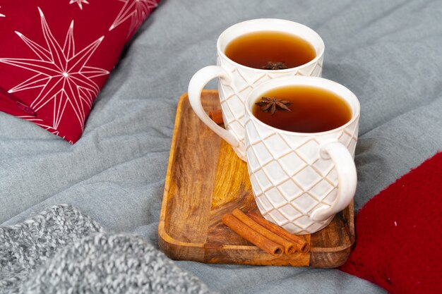 Close up shot of a cups of tea on wooden board at a christmas interior