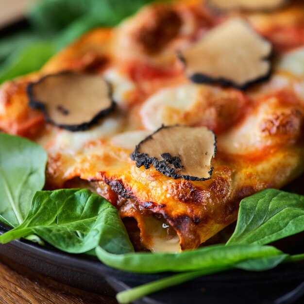 Close up shot of a delicious gourmet slice of lasagna bolognese on a wooden board