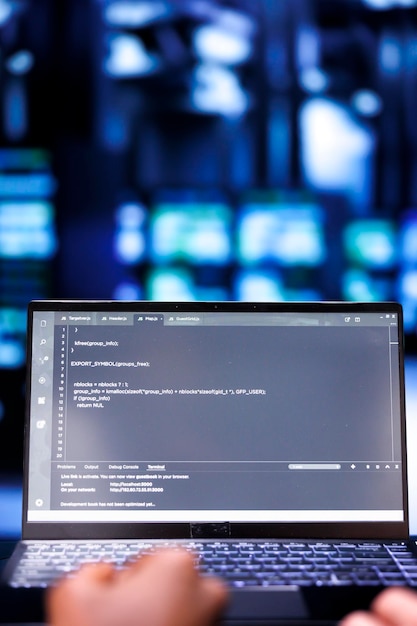 Photo close up shot of developers updating server rigs, writing complex binary code scripts on laptop. programmers using javascript, java, and database programming to fortify cybersecurity in data center