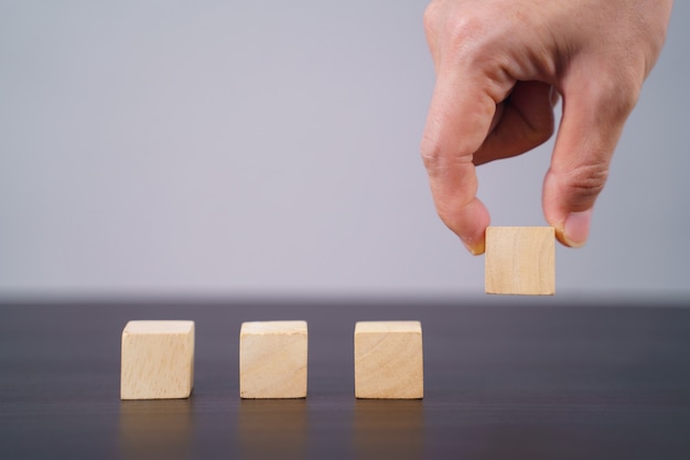 Close up shot of empty wooden blocks on table isolated on gray.